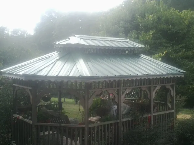 Two tier green metal roof on a garden gazebo in Grant